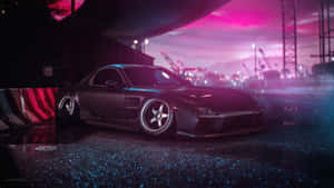 A Black Car Is Parked In A Parking Lot At Night Wallpaper