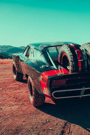 A Black Car With Tires Wallpaper