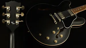 A Black Guitar With A Black Headstock Wallpaper