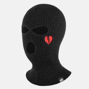 A Black Knitted Mask With A Heart On It Wallpaper