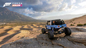 A Blue Jeep Is Driving On A Rocky Hill Wallpaper