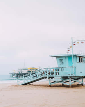 A Blue Lifeguard Tower On The Beach Wallpaper