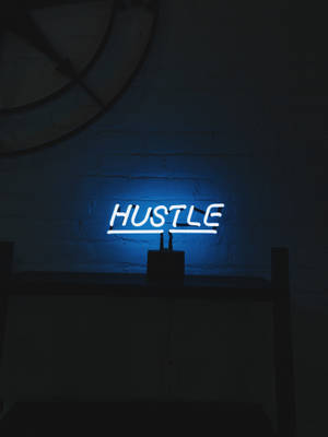 A Blue Neon Sign With The Word Hustle On It Wallpaper