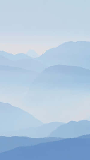 A Blue Sky With Mountains In The Background Wallpaper