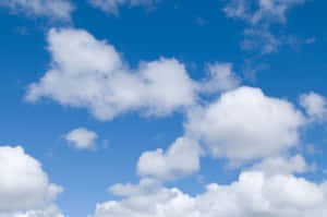 A Blue Sky With White Clouds Wallpaper