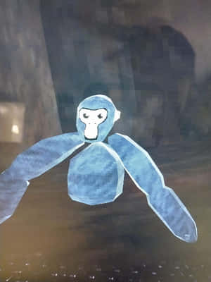 A Blue Stuffed Animal Is Sitting On A Table Wallpaper