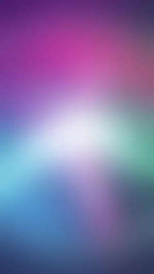 A Blurred Background With A Colorful Light Wallpaper