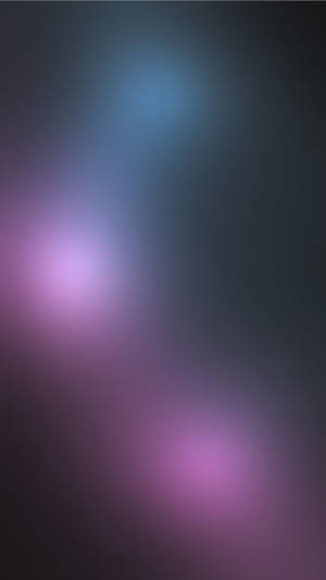 A Blurry Background With Purple And Blue Lights Wallpaper