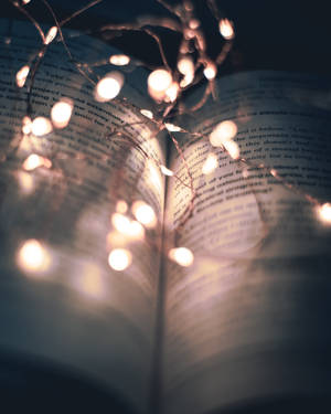 A Book With Lights On It Wallpaper