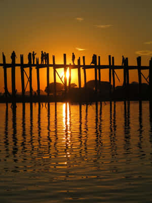 A Breathtaking Sunset Behind U Bein Bridge Near Mandalay Wallpaper