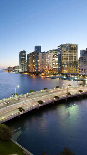 A Bridge Over The Water With Buildings And Skyscrapers Wallpaper