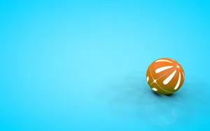 A Bright Orange Beach Ball Floating Against A Pristine Blue Sky Wallpaper