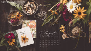 A Calendar With Flowers And A Notebook On It Wallpaper