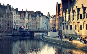 A Canal With Buildings On Either Side Wallpaper