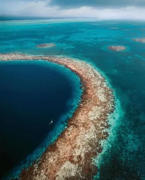 A Captivating View Of The Great Blue Hole, An Underwater Sinkhole Off The Coast Of Belize. Wallpaper