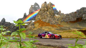 A Car Driving Down A Mountain Road Wallpaper
