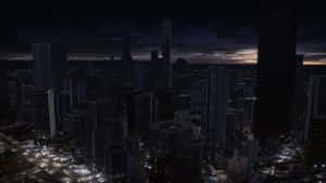 A City At Night With Tall Buildings Wallpaper