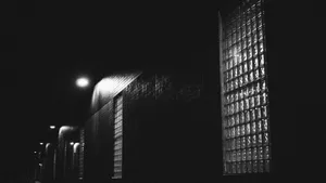 A City Skyline At Night Illuminates The Beauty Of Black Aesthetic. Wallpaper