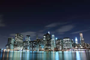 A City Skyline At Night Wallpaper