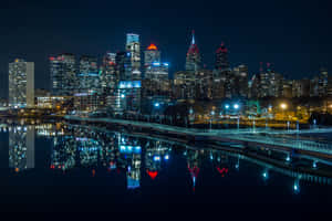 A City Skyline Is Reflected In The Water Wallpaper