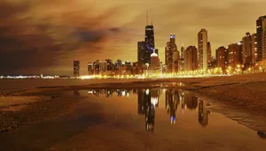 A City Skyline Is Reflected In The Water Wallpaper