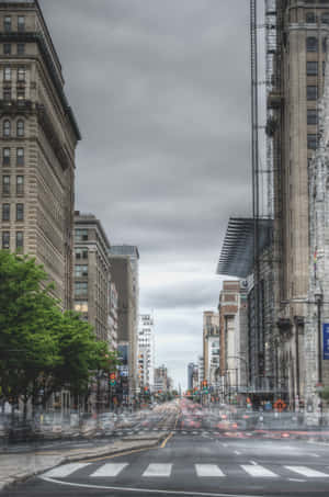 A City Street With A Lot Of Traffic Wallpaper