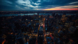 A Cityscape At Dusk With A City Skyline Wallpaper