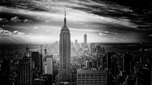 A Cityscape Silhouetted Against Night Sky Wallpaper