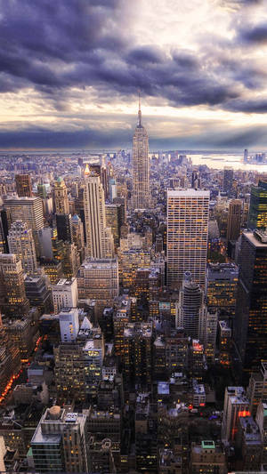 A Cityscape With Buildings And Clouds Wallpaper