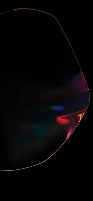 A Close Up Of A Black Object With A Rainbow Colored Light Wallpaper
