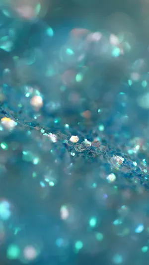 A Close Up Of A Blue Water With Glitter Wallpaper