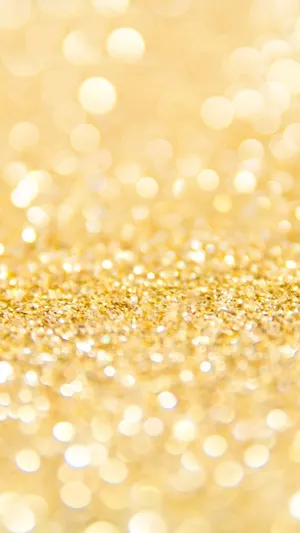 A Close Up Of A Gold Glitter Background Wallpaper