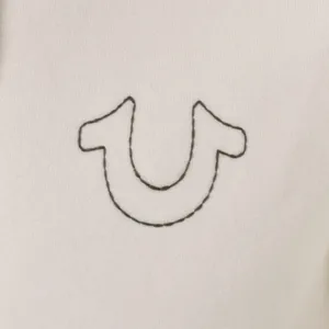A Close Up Of A White Shirt With A U Embroidered On It Wallpaper