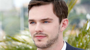 A Close-up Shot Of Actor Nicholas Hoult With A Bright Expression. Wallpaper