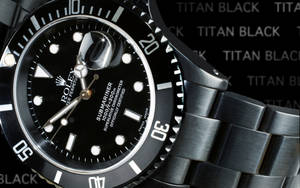 A Close-up View Of The Rolex Logo On A Submariner Watch Wallpaper