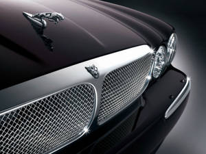 A Closer Look At The Sleek Monochrome Front Bumper Of A Jaguar Car Wallpaper