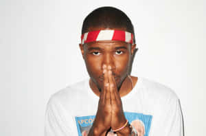 A Closeup Of Artist Frank Ocean Working On His Laptop Wallpaper