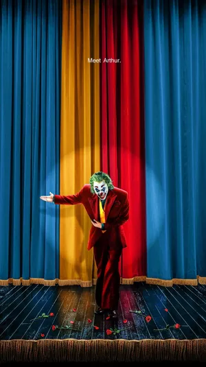 A Clown Is Standing On A Stage Wallpaper
