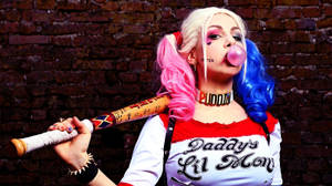 A Cosplayer Dressed As The Iconic Dc Comic Character, Harley Quinn. Wallpaper