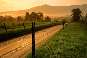 A Cowboy Enjoys A Sunset In The Western Ranch Wallpaper