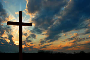 A Cross In The Middle Of A Field Wallpaper