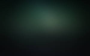 A Dark Green Background With A Blurred Background Wallpaper