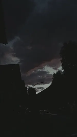 A Dark Sky With Clouds Wallpaper