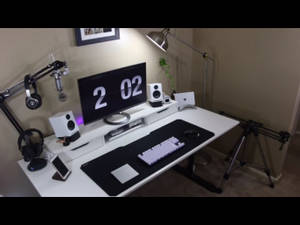 A Desk With A Monitor, Keyboard, Mouse And Other Equipment Wallpaper