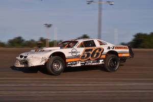 A Dirt Track With A Race Car Wallpaper