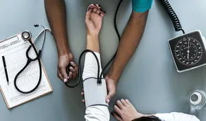 A Doctor Is Taking A Patient's Blood Pressure Wallpaper