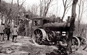 A Duo And Their Trusty Vintage Steam Tractor Wallpaper