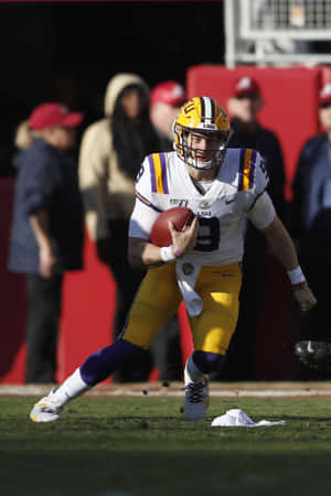 A Football Player Running With The Ball Wallpaper