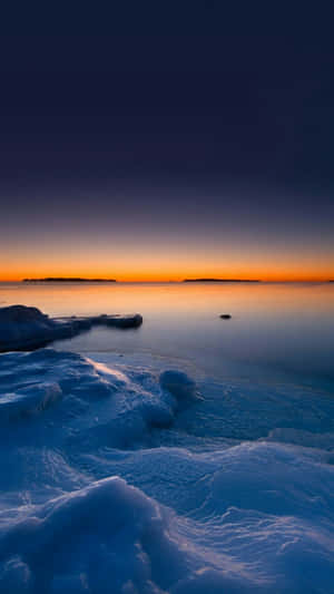 A Frozen Lake With Ice And Snow On It Wallpaper