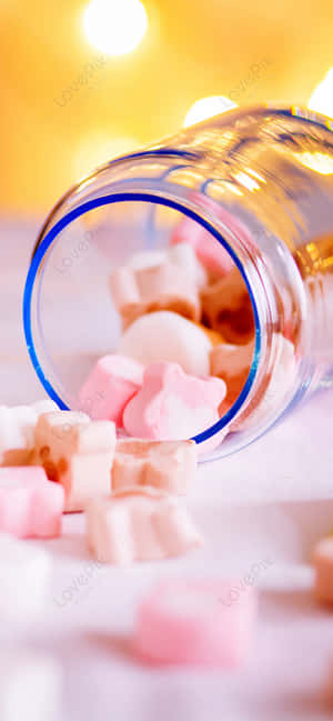 A Glass Bottle With Candy In It Wallpaper